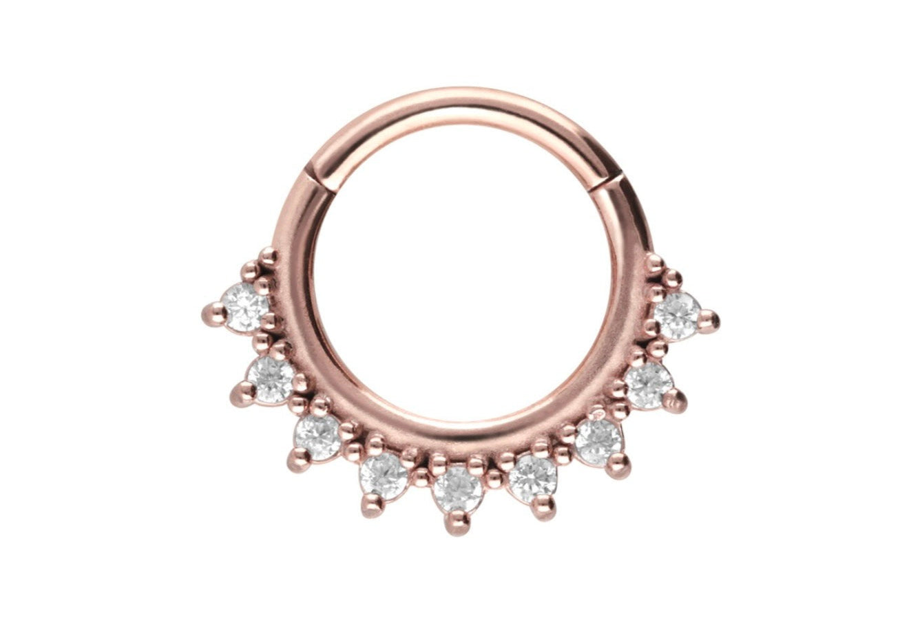 rose gold septum jewelry with dainty crystals along the outer side of the hoop